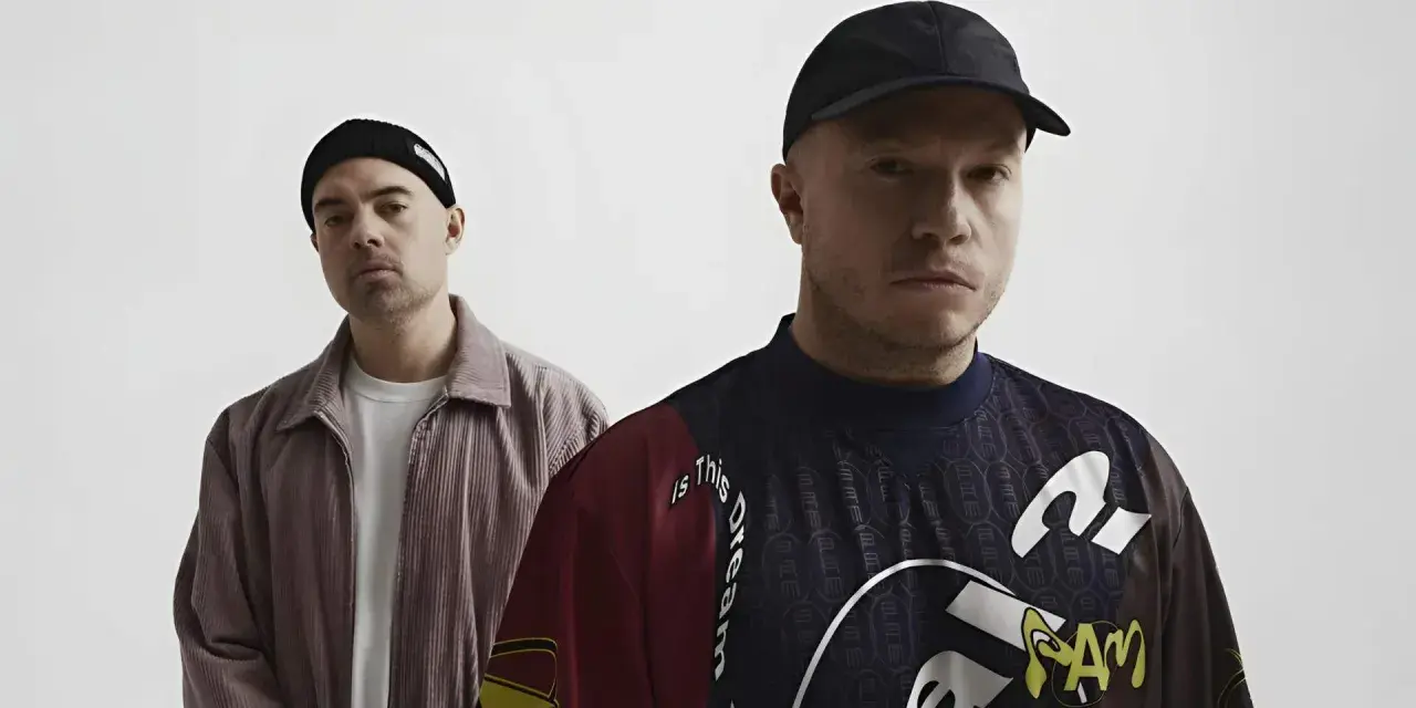 Dwóch mężczyzn w czapkach, jeden w sztruksowej kurtce, drugi w bluzie z napisem "Is this dream". Czy to zapowiedź problem koncertów 2025?