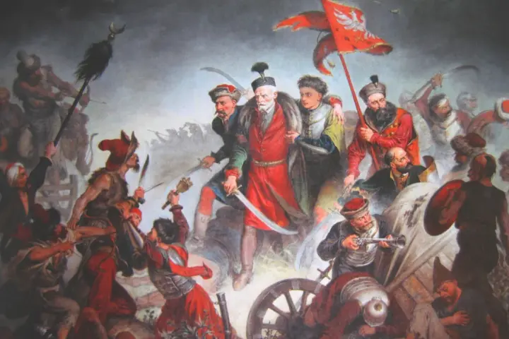 Bitwa pod Chocimiem 1621: Polacy z chorągwią zwyciężają. Dynamiczna scena walki, szable, broń palna, żołnierze w barwnych strojach.